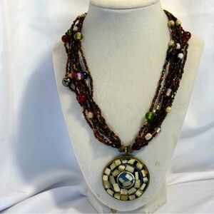 Bold Mosaic Brass Pendant Necklace with Multistrand Beads and Vibrant Accents.